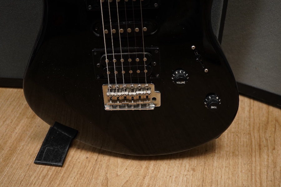 A Yamaha ERG121 electric guitar in black finish, with a soft gig case